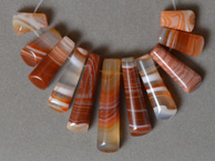 11 graduated trapezoid beads from red and white agate.
