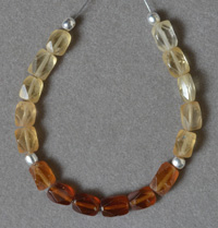 Small finely faceted Hessonite garnet beads.