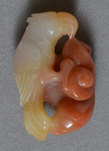 Parrot carved from red agate with yellow opal.