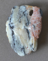 Yellow/white opal with red speckled bird carving.
