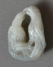 White opal carving of two birds with amazonite back.