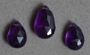 Three faceted amethyst drop beads.