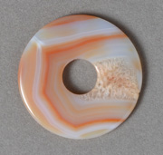 Orange and white onyx tai-ky pendant bead.
