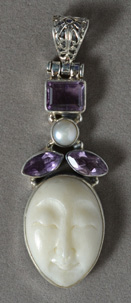 Sterling silver pendant with amethyst and carved bone.