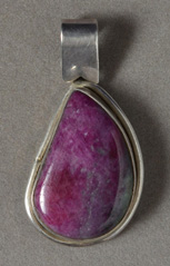 Silver pendant with ruby cabochon.