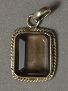 Pendant from faceted smoky quartz with silver bezel.