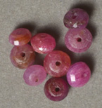 Nine ruby rondelle beads.