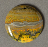 Yellow band opal flat round bead.