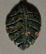 Carved leaf pendant bead from plumite jasper.