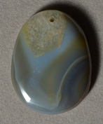 Piranha agate oval pendant bead.