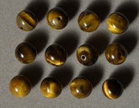 Twelve tiger eye round beads.