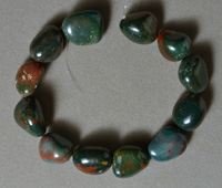 Tumbled nugget beads from heliotrope bloodstone.