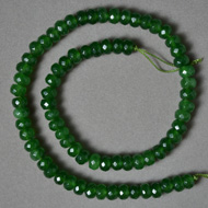Faceted rondelle beads from emerald green chalcedony.