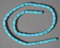 Blue turquoise drum beads with black lines.