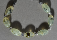 Prehnite barrel beads  with star spacers.