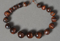 Tiger eye micro faceted graduated round beads.