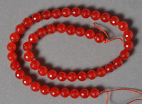 Micro faceted ruby colored jade round beads.
