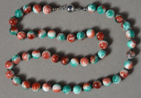 Red, white and blue-green jadeite round beads.