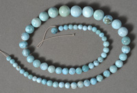 Strand of blue larimar round beads in graduated sizes.