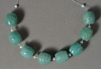 Several wide barrel beads from green aventurine.