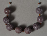 Carved round beads from sunset agate.