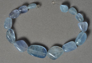 Light blue fluorite tumbled nugget beads.