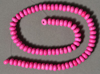 Dyed fuschia colored turquoise rondelle beads.