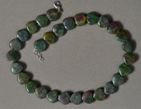 Heart shaped carved ruby zoisite beads.