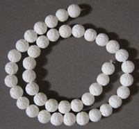 Carved White coral round beads.