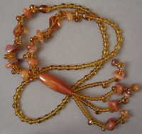 Necklace with amber colored glass and agate beads.