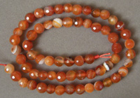 Faceted round beads from carnelian agate.