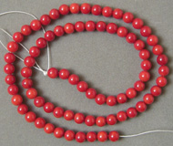 Strand of 5mm red coral round beads.