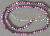 Small round beads from faux sugilite.