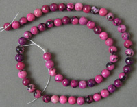 Dyed rhodonite round beads.
