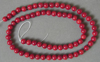 Strand of 6mm red coral round beads.