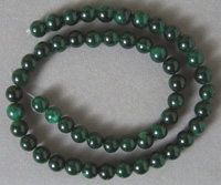 Round beads from dark green quartzite.