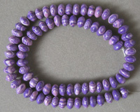Man made gemstone rondelle beads with purple stripes.