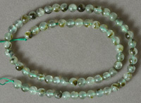 Round beads from light green prehnite.