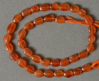 Flat oval beads from red carnelian.
