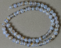 Round beads from blue chalcedony with inclusions.