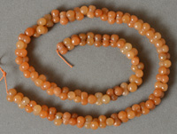 Bone shaped beads from orange aventurine.