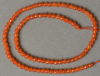 Faceted round beads from South American orange topaz.