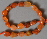 Strand of tumbled carnelian nugget beads.