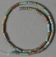 Tube or long drum shaped beads from rainbow calsilica.