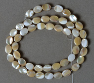Small oval beads from mother of pearl shell.