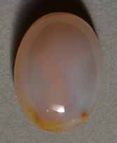 Chalcedony oval cabochon with phantom.