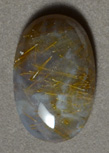 Sagenite cabochon with rutiles.